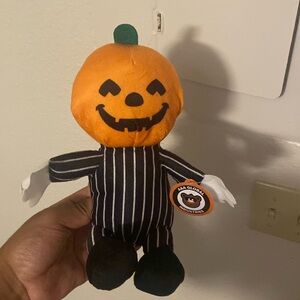 A Halloween Pumpkin head stuffed bear